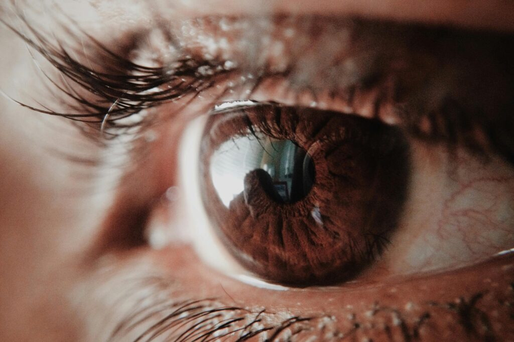 Detailed macro shot of a human eye capturing intricate details of the iris and reflections.